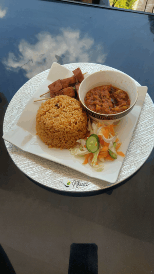Jollof Rice with cabbage stew vegetable stew and kebabs